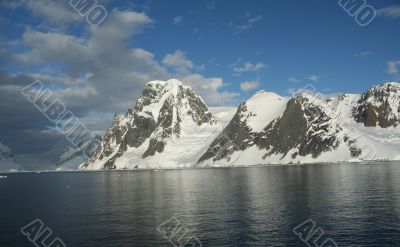 Reflections of glacial icefalls and mountains