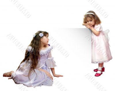 Two small girls in beautiful gowns.