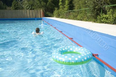 child is swimming with safety-wings