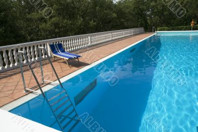 blue bed near the swimmingpool