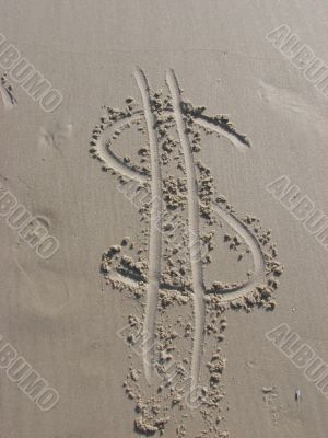 Dollar sign in sand
