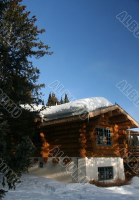 Mountain hut with snow on roof