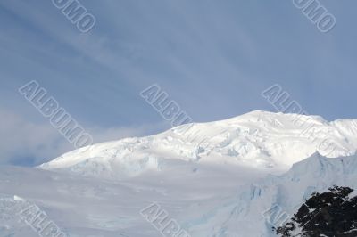 Glaciers and icefalls on snowy mountain peak