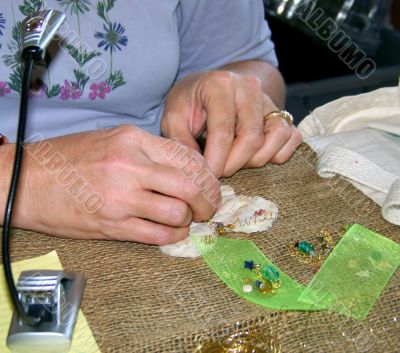 Woman`s Hands Crafting an Ornament