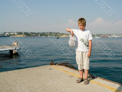 boy with sea at background
