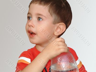 The boy with a bottle on a white background