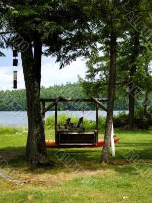 Wooden swing overlooking lake