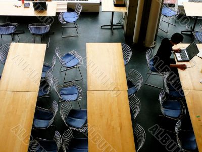 Man on laptop computer in university building