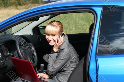 young woman with notebook in car