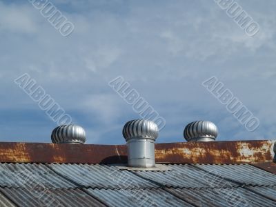 Three ventilators on a roof
