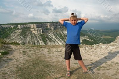 boy against a mountain valley