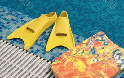 Yellow flippers and swimming board