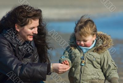 mother and cute boy on the beach