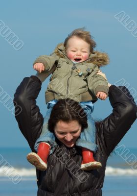 mother and cute boy on the beach