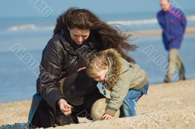 mother and cute boy on the beach
