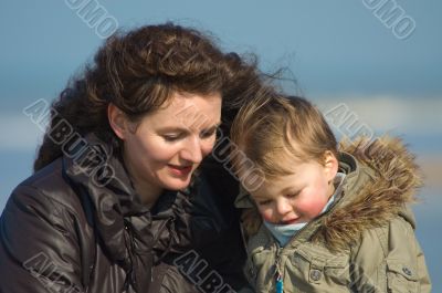 mother and cute boy on the beach