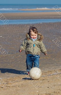 cute little boy playing soccer