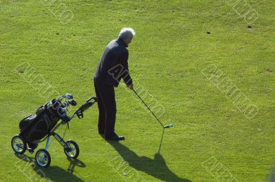 senior man playing golf
