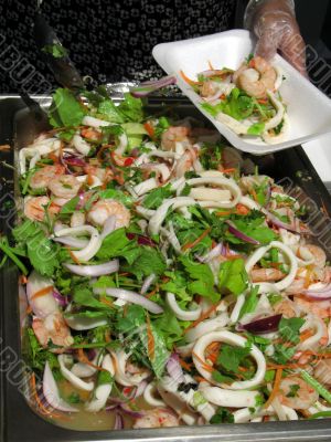 Chef serving seafood salad