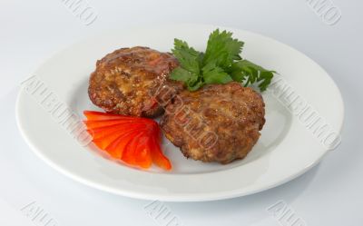Сutlets with tomato and parsley.