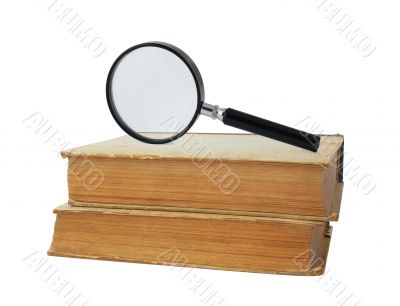 two old books and magnifying glass