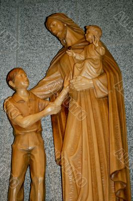 woodcarved jesus and children