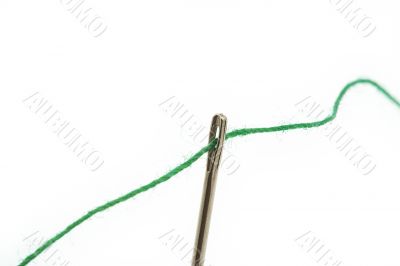 threaded needle on white