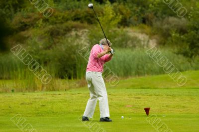senior man playing golf