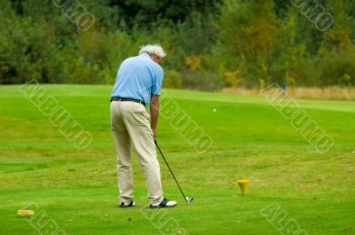senior man playing golf