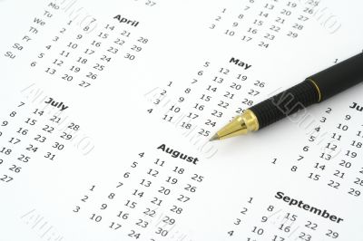 calendar and ballpoint pen