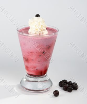 Bilberry mousse with vanilla cream in a glass.
