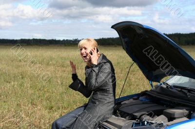 woman with her broken car