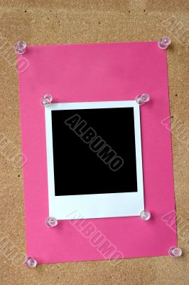photo frame thumbtacked to cork board