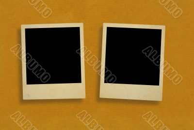 two old photo frames against rough paper