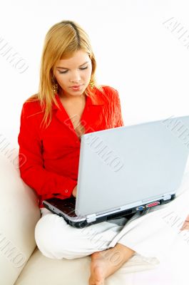 Women with laptop on couch