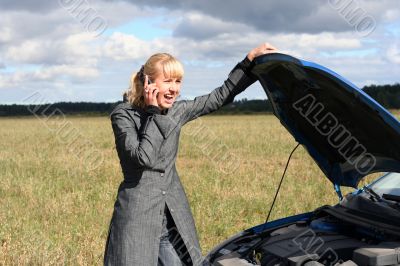 young woman with her broken car