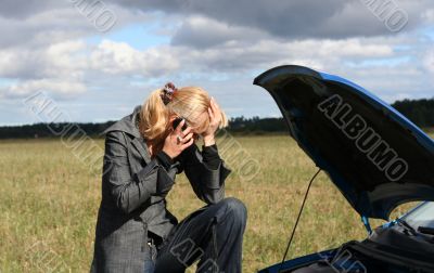 young woman with her broken car