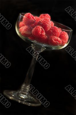 Glass bowl with raspberries