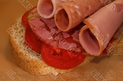 Sandwich with sausage and tomatoes close up