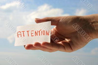 hand holding attention card