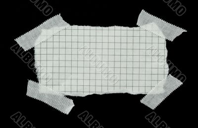 squared strip of paper with white plaster pieces
