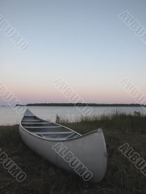 canoe on beach at sunset
