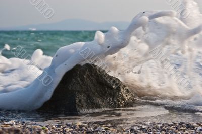 Sea wave gushing over the rock