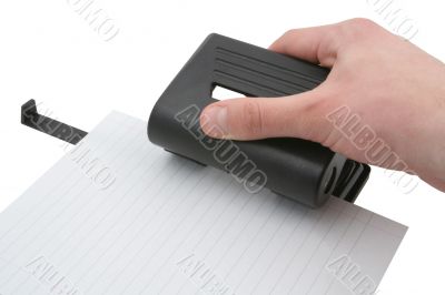 hand punching lined paper page