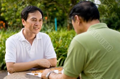 Smiling Man Playing Chess