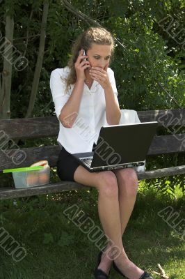 Businesswoman in the park; shock