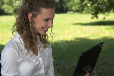 Happy businesswoman in the park
