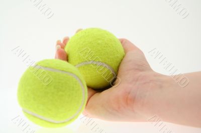 hand with two tennis balls