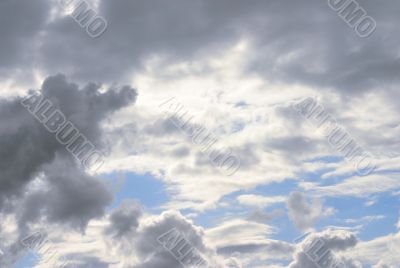 massive stormy clouds against bright blue sky
