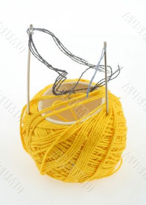 yellow thread and needles on white